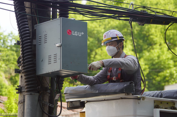 서울 서초구 모처에서 LG유플러스 직원이 전신주에 매달린 HFC 전원공급장치를 철거하고 있는 모습