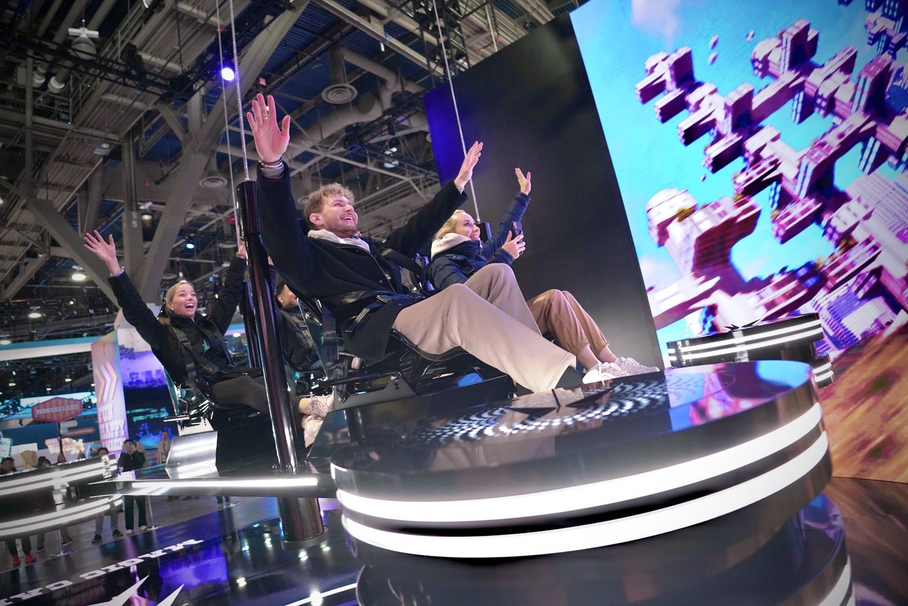 SK그룹 전시관에서 UAM을 형상화한 ‘매직 카펫’에 탑승해 AI 기반 친환경 미래교통체계를 체험하는 모습.